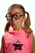 Little girl wearing big round glasses makes a silly expression