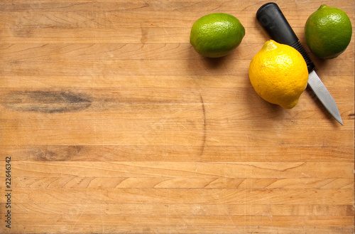 Photo: A lemon and limes on a worn butcher block cutting board A lemon and limes on a worn butcher block cutting board