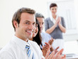 Smling business people applauding a good presentation