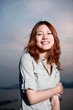 Beautiful young woman on the beach at sunset .