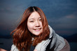 Beautiful young woman on the beach at sunset .