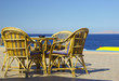 table and chairs set at the coastline