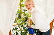 Foto: Woman watering the flowers at home Woman watering the flowers at home