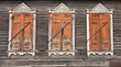 Three old faded wooden windows with closed shutters Three old faded wooden windows with closed shutters