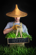 Man with Asian hat gardening