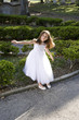 Photo: Beautiful child in white dress playing outdoors Beautiful child in white dress playing outdoors