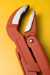 red water pump pliers on yellow background