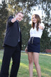 Businessman and businesswoman showing thumbs up