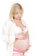 Pregnant woman with hands over tummy