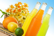 Three ice cold beverages with some fruits around them