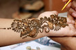 Applying henna on hand