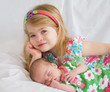Photo: Sister Laying with New Baby Sister Sister Laying with New Baby Sister