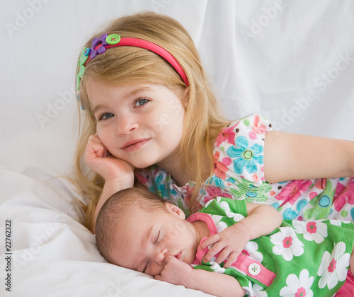 Photo: Sister Laying with New Baby Sister Sister Laying with New Baby Sister