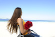 woman in wheelchair with red roses