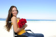 woman in wheelchair with red roses