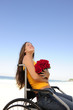 woman in wheelchair with red roses