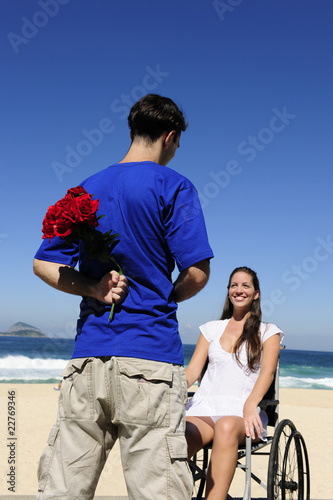 Photo: man hiding red roses, a gift for his handicapped girlfriend man hiding red roses, a gift for his handicapped girlfriend