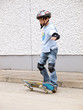 child skateboarding with helmet, knee pads & elbow protection