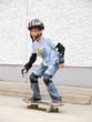 child skateboarding with helmet, knee pads & elbow protection