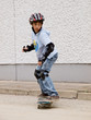 child skateboarding with helmet, knee pads & elbow protection
