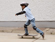 child skateboarding with helmet, knee pads & elbow protection