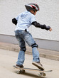 child skateboarding with helmet, knee pads & elbow protection