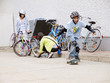 children with bicycles & skateboard wearing helmets