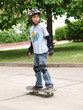 child skateboarding with helmet, knee pads & elbow protection
