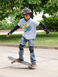 child skateboarding with helmet, knee pads & elbow protection