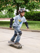 child skateboarding with helmet, knee pads & elbow protection