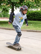 child skateboarding with helmet, knee pads & elbow protection