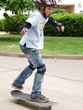 child skateboarding with helmet, knee pads & elbow protection