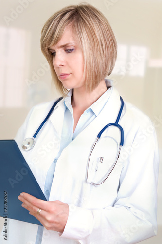 Photo: Female doctor holding a writing pad Female doctor holding a writing pad