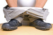 man's feet and toilet