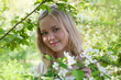 Young woman in spring blossom of apple trees Young woman in spring blossom of apple trees