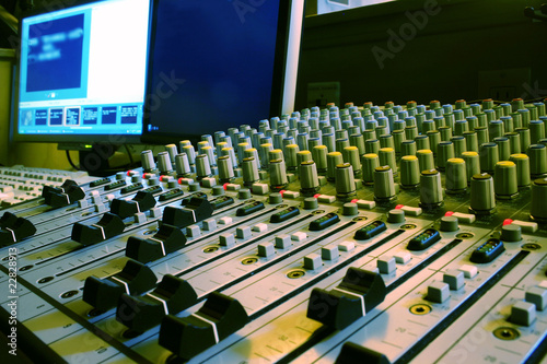 Photo: Sound mixer, closeup of the knobs with computer. Sound mixer, closeup of the knobs with computer.
