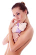 Topless girl hides behind  teddy bear