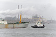 Tug pulling ship into the harbour Tug pulling ship into the harbour