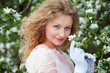 beautiful young woman in white gloves with flowers