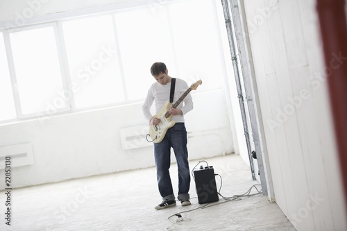 Photo: Young man playing electric guitar Young man playing electric guitar