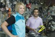 Female cyclist buying helmet at bike shop cash desk