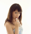 Prettty woman puts on lipstick