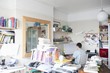 Creative professional sits at computer in corner of office