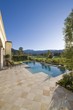 Paved poolside area and summer landscape