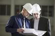 Two colleagues consult file documentation
