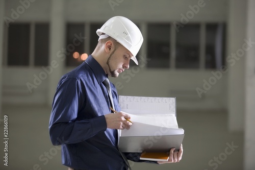 Photo: Young man holds documentation file Young man holds documentation file