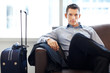Young business executive waiting for his flight at airport