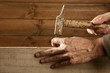 Carpenter hands with hammer wood and nail Carpenter hands with hammer wood and nail