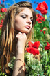pensive girl in poppy field