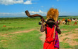Masai warrior playing traditional horn Masai warrior playing traditional horn